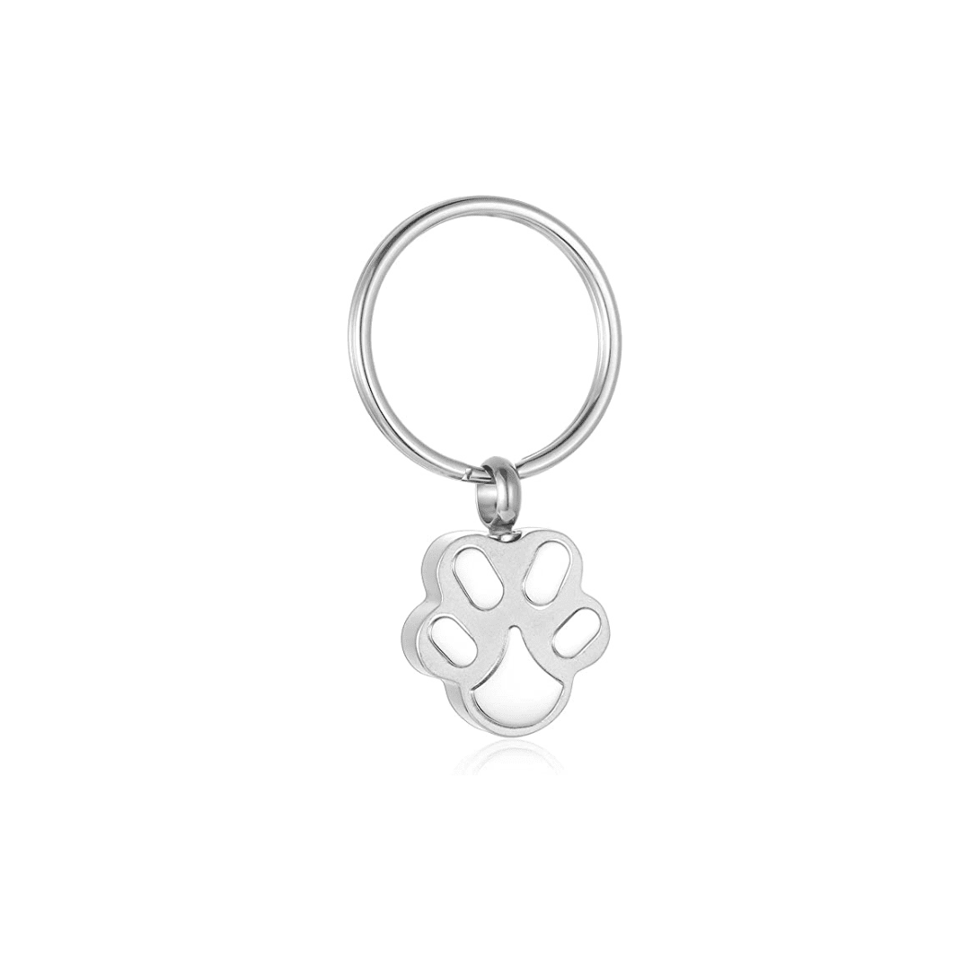 A sterling silver paw print charm on a white background.
