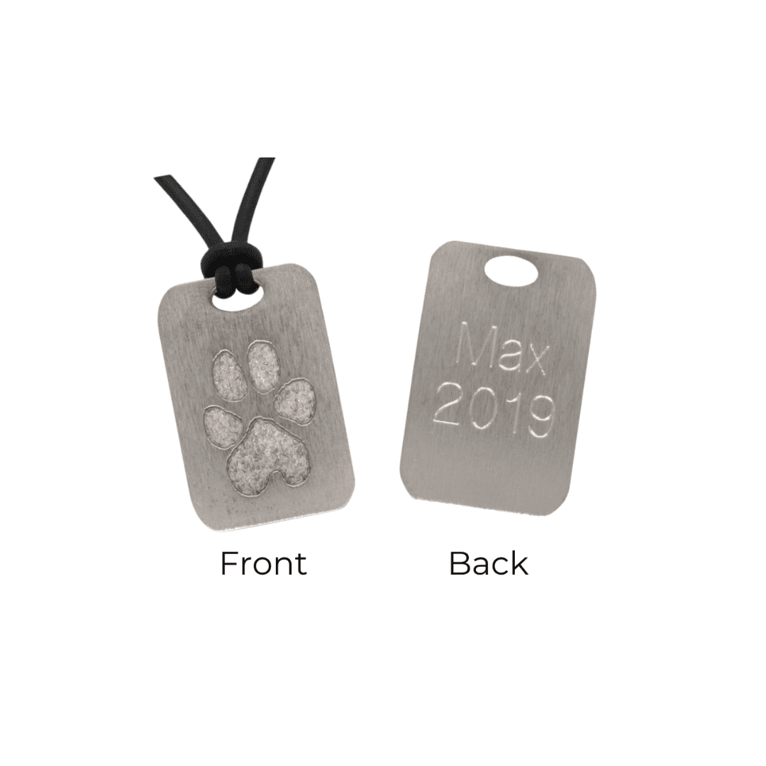 A dog tag with a paw print on it.