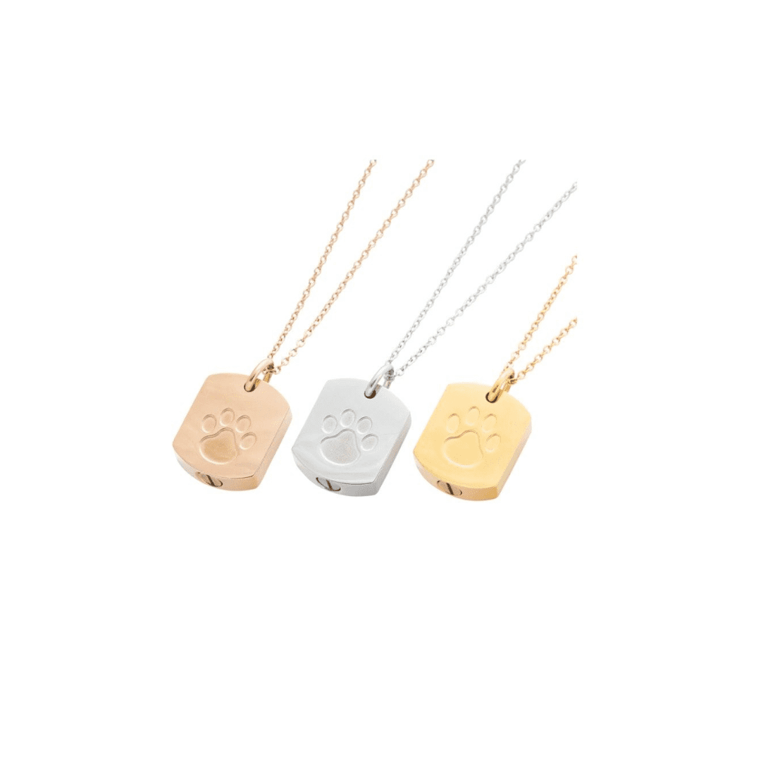 Three dog tag necklaces with paw prints on them.