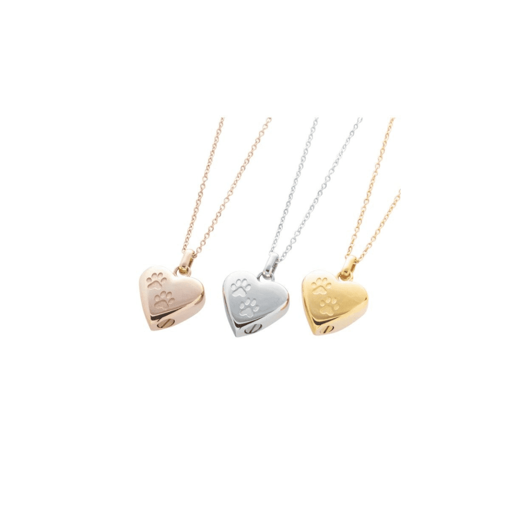 Three gold and silver heart locket necklaces on a white background.
