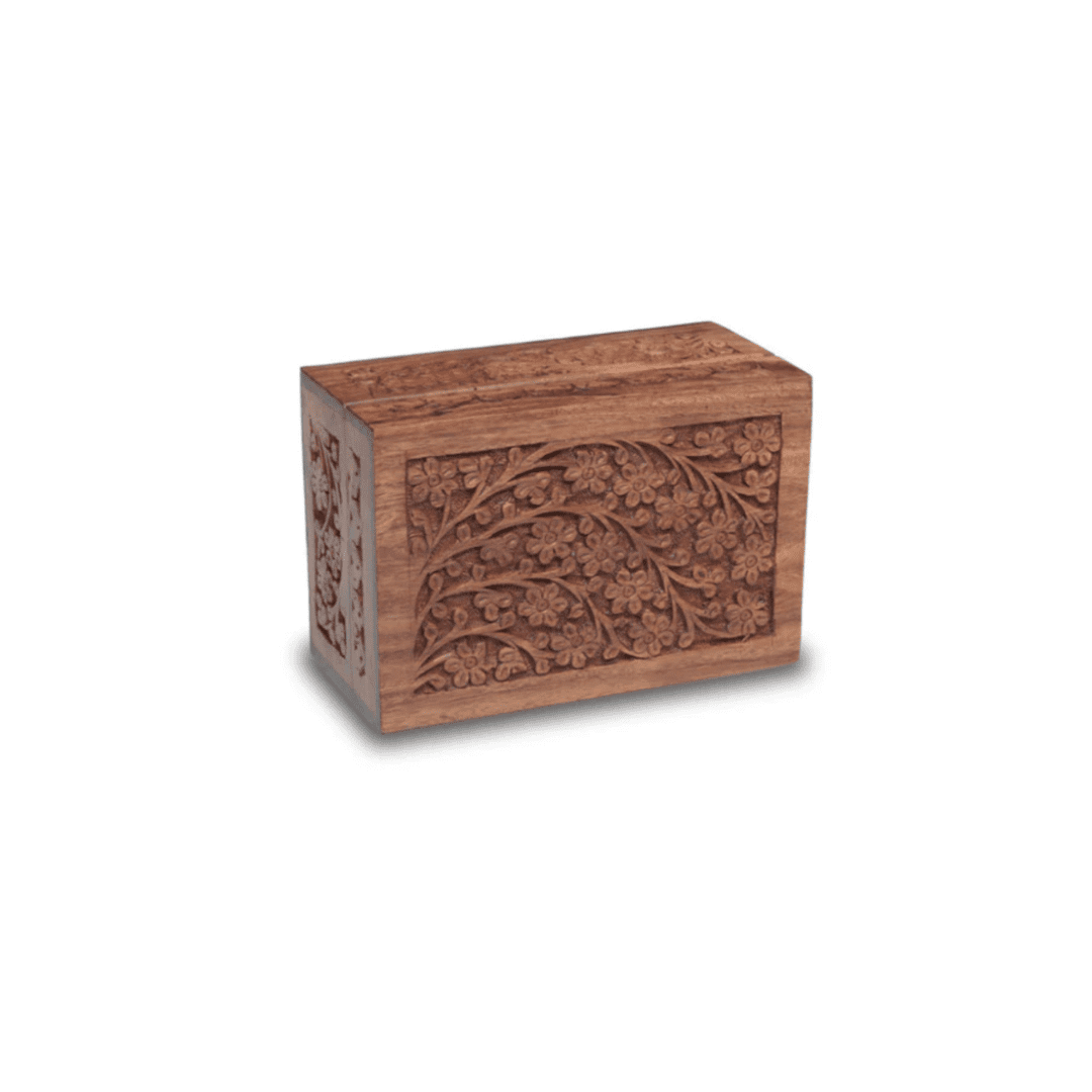 A wooden box with intricate carvings on it.