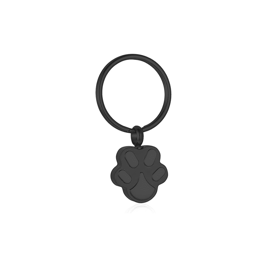 A black key ring with a paw print on it.