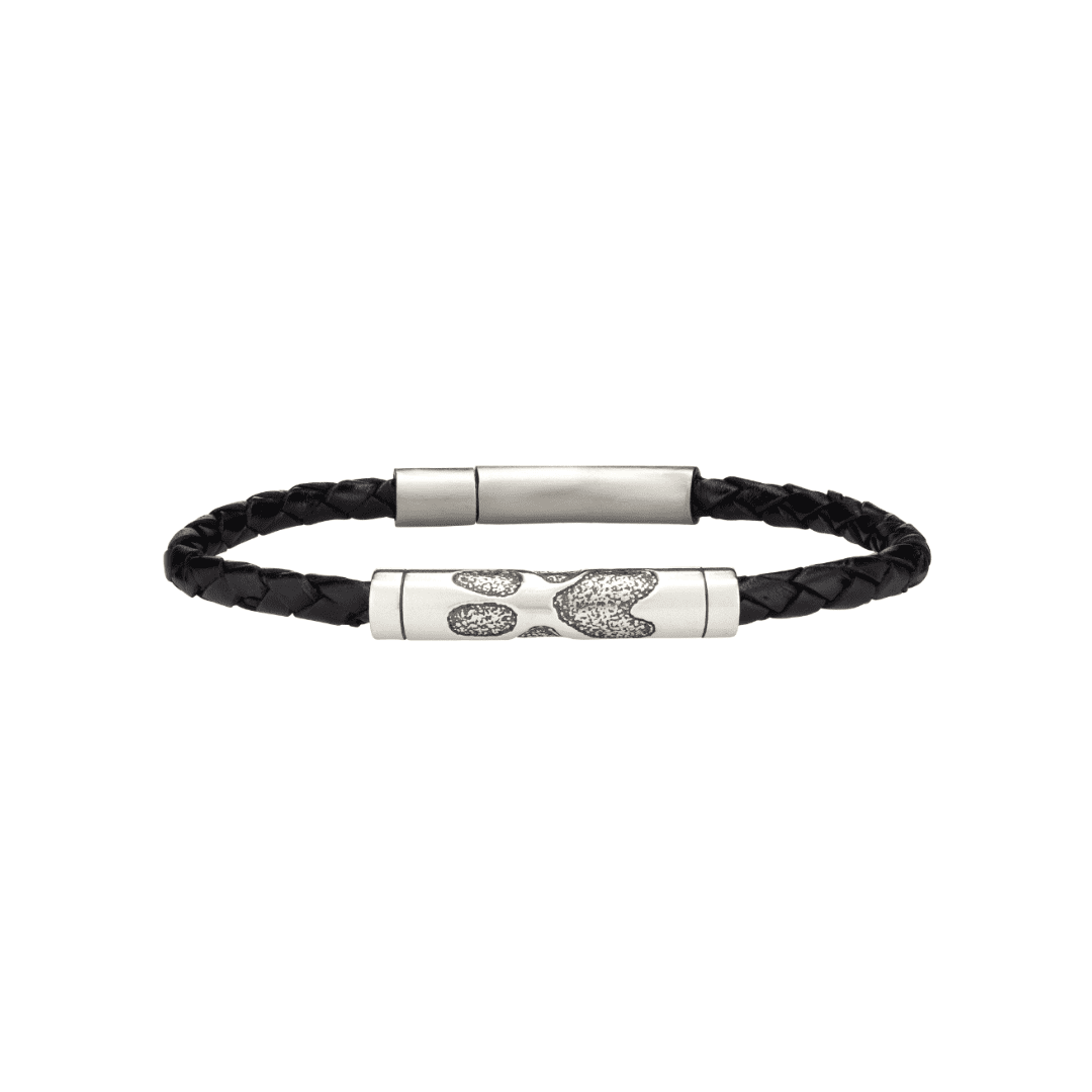 A black leather bracelet with a silver clasp and diamonds.